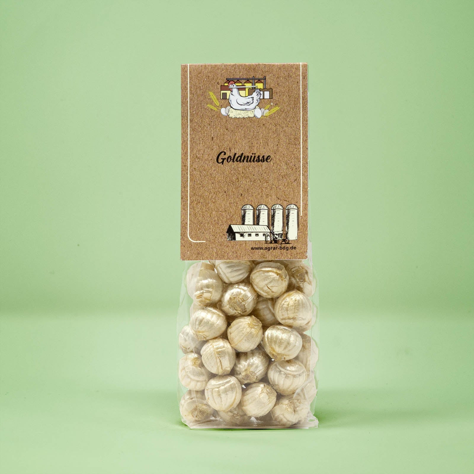 Frontalansicht von Goldnuesse Bonbons in einer transparenten Plastiktüte mit einem Pappetikett.