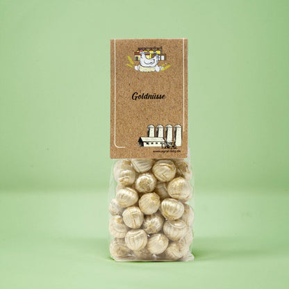 Frontalansicht von Goldnuesse Bonbons in einer transparenten Plastiktüte mit einem Pappetikett.