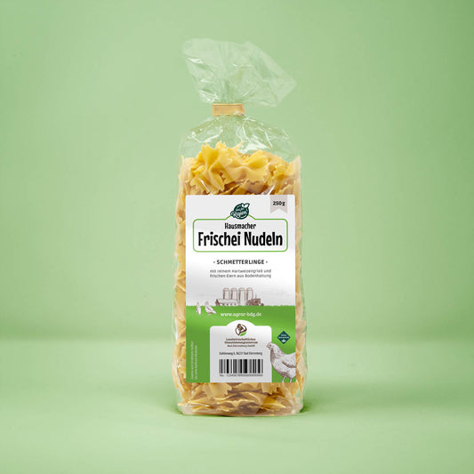 Frontalansicht von Hausmacher Frischei Schmetterling Nudeln 250 Gramm in einer Plastiktüte mit Etikett.